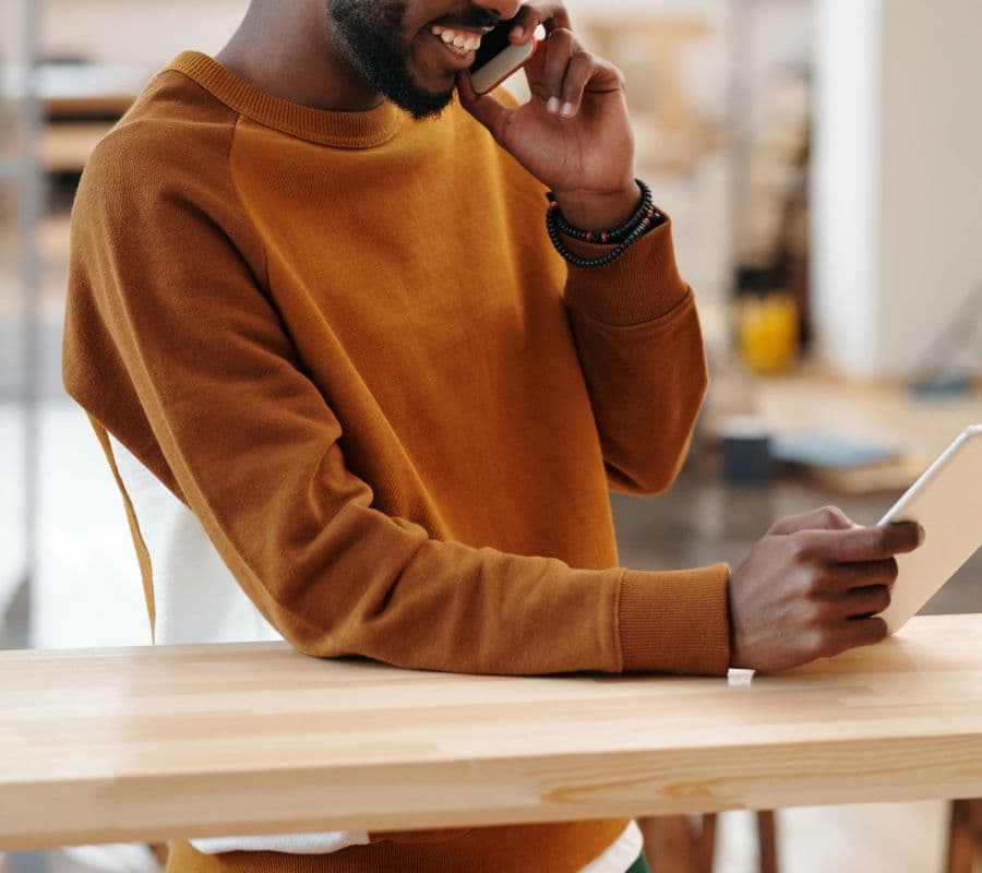 A man on a phone call at a desk
